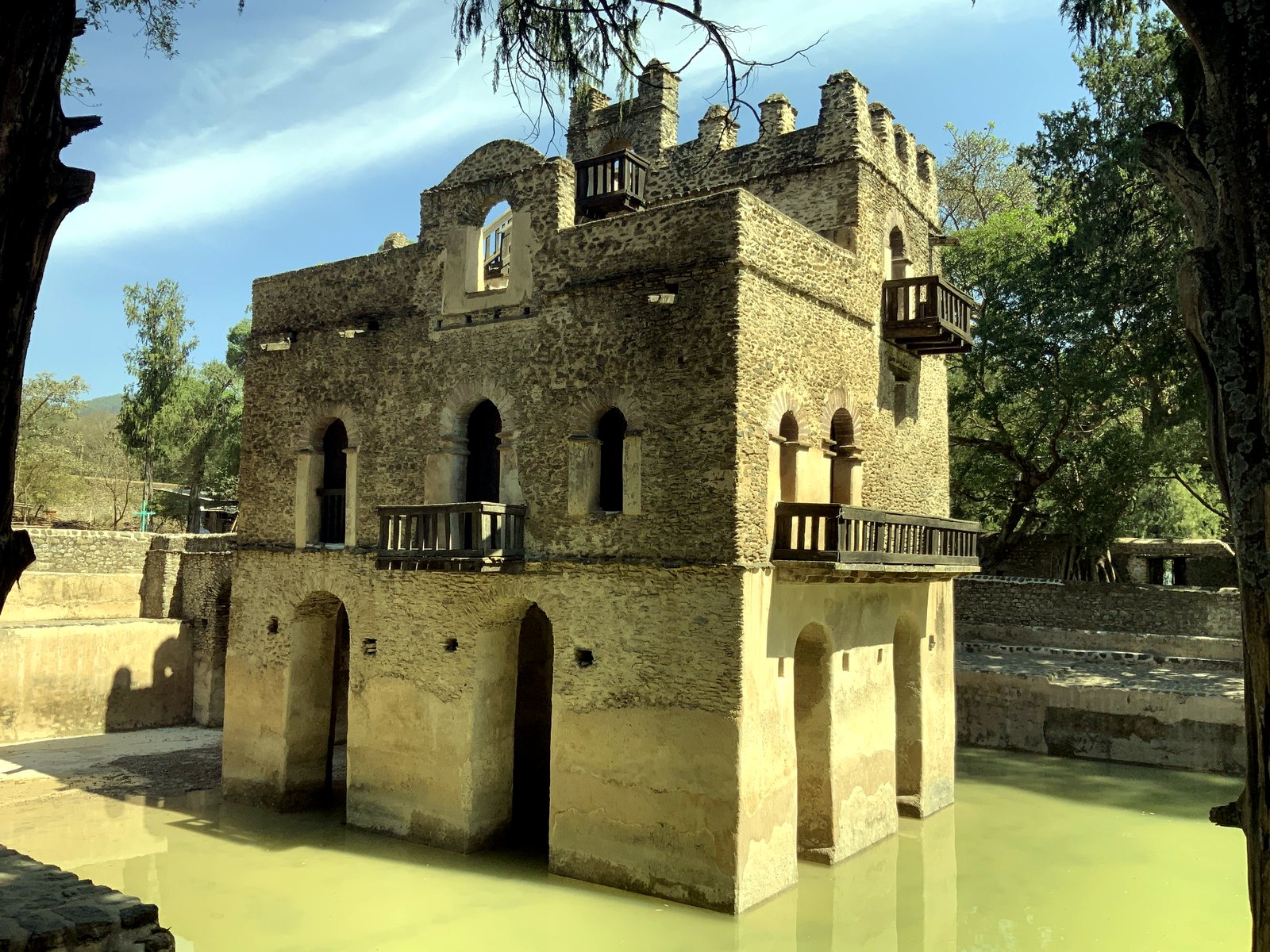 Gondar water castle reflected in still water.