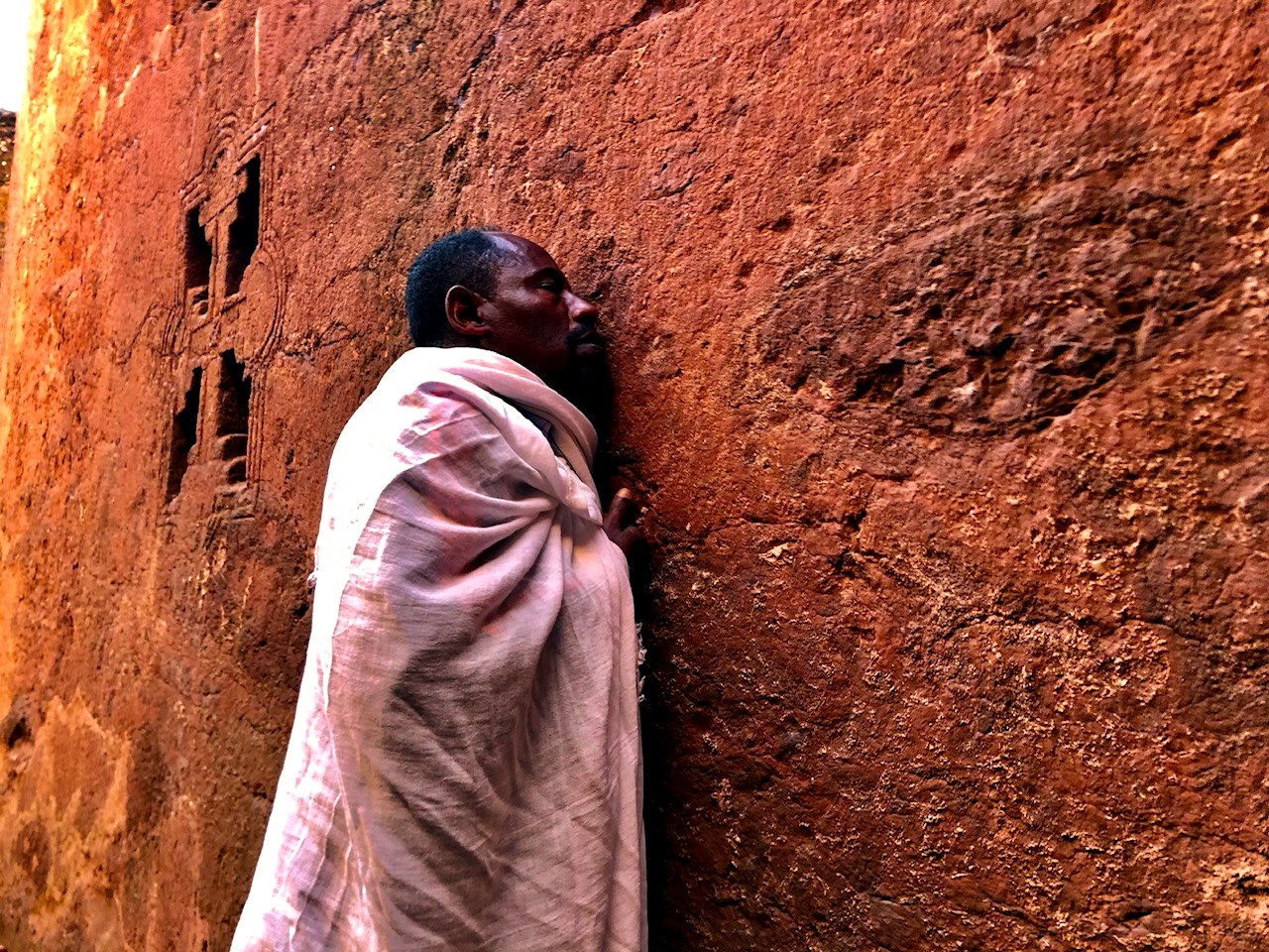 Textured prayer wall detail for a heritage-focused route.